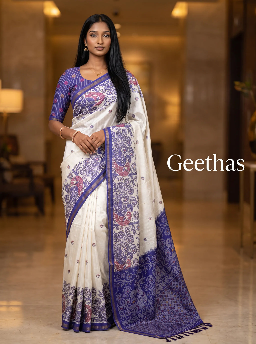 Model wearing white and violet slub linen printed saree with ornate violet pallu and tasselled finish