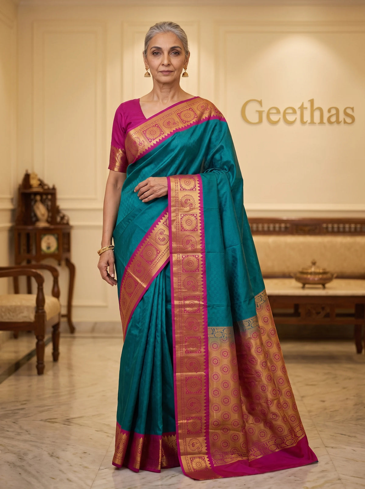 Model wearing a teal blue semi silk saree with magenta zari border and ornate pallu